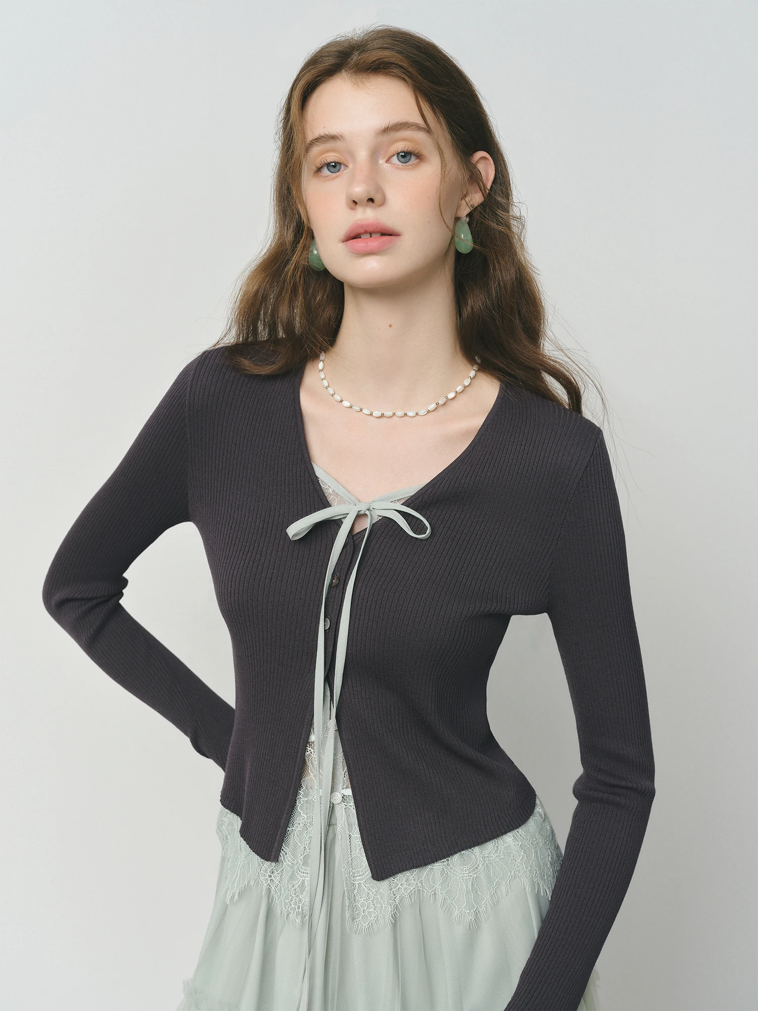 Women's knit cardigan with lace trim and tie detail Soft knit women's cardigan featuring lace trim and front tie detail
